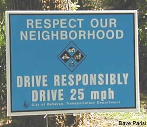 Sign reads "Respect our Neighborhood Drive Responsibly Drive 25 mph"